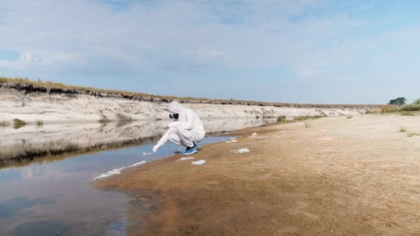 Man Protective Costume Gas Mask Respirator Takes Water Analysis Test — Stock Video