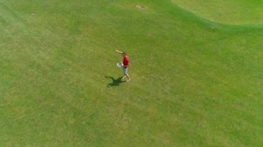 Parkta elinde bir Vr kulaklık alır ve yön noktaları adam, havadan görünümü. Kasklı genç adam doğanın arka planında artırılmış gerçeklik yaşıyor. 4k drone görüntüleri.
