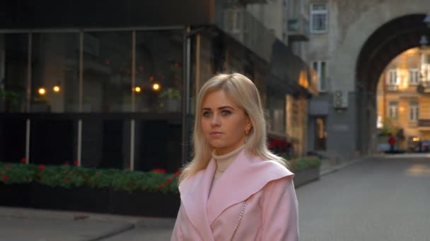Young Attractive Blonde Woman Pink Coat Stands Background Modern Architecture — Stock Video