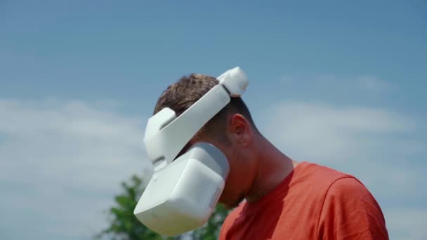 Man in a virtual reality helmet lowers his head down — Stock Video