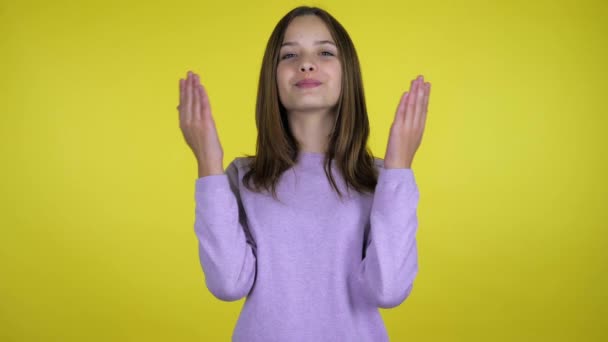 Adolescente menina levanta as mãos para cima, descansando palmas nos lábios, em seguida, pega e sorri — Vídeo de Stock