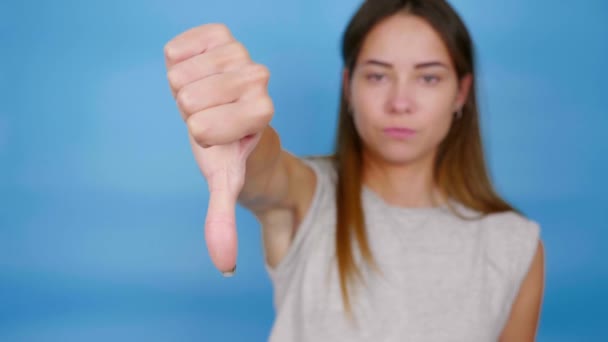 Beautiful Serious Woman Gray Shirt Raises Hand Shows Thumb Dislike — Stock Video