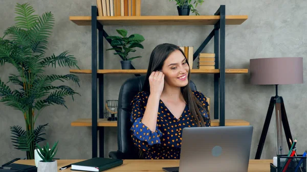 Smiling woman connects to remote online video conference with company employees