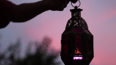 Ramazan kutsal ay Şafağı. Müslüman hızlı günbatımı için şafak gelen her gün. Siluet. Bir fener tutan adam