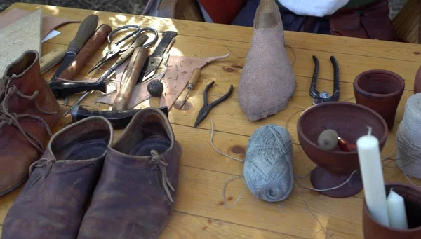 Workshop Shoemaker Middle Ages Leather. Medieval shoemaker tools. Hand Made Shoe Making. The profession of cobbler and cordwainer. 14th Century Lace Low Boots