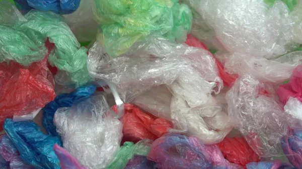 Discarded used plastic bags form a big pile on a green background. Plastic pollution is the accumulation of plastic objects and particles in the Earth\'s environment. Chroma Key