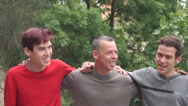 Happy Adult Father Teenage Sons Hugging Talking Laughing — Stock Video