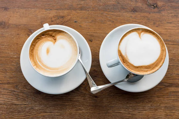 Pair of cappuccinos with heart — Stock Photo, Image