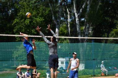 Orenburg, Russia, 9-10 June 2017 year: Boys playing beach volleyball clipart