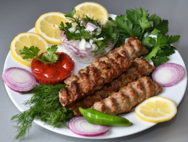 Akdeniz mutfağında taze bitkilerle Lula kebabı.