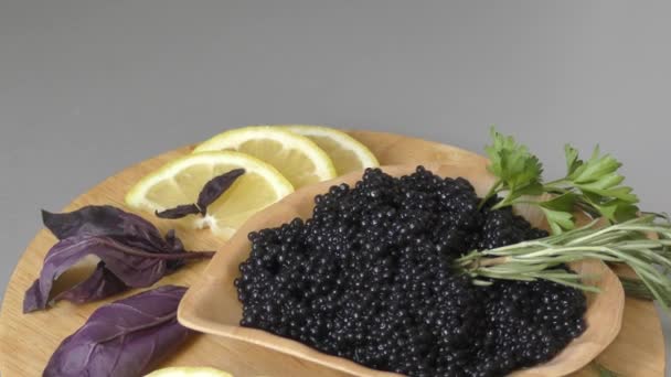 Black caviar with fresh herbs on a cutting board — Stock Footage Black Caviar Fresh Herbs Cutting Board Stock Video