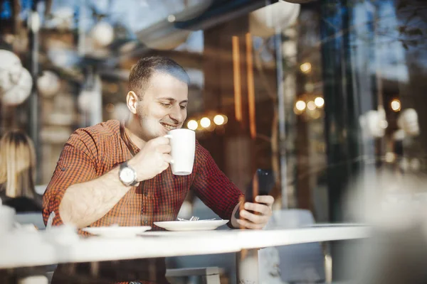 Young attractive man drinking coffee at lunch time