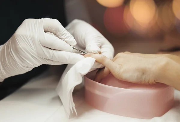 Close up Manicurist Pushing Cuticles On Nails With Stick For Cuticle.