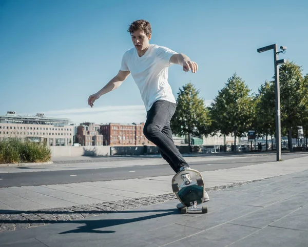 Giovane uomo attraente equitazione longboard nel parco . — Foto Stock