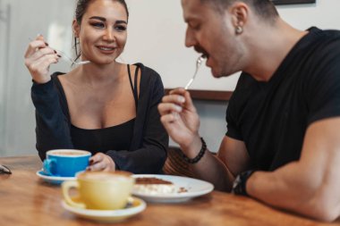 Tarihte kafede oturup, kahve içme ve tatlı yeme genç çift.