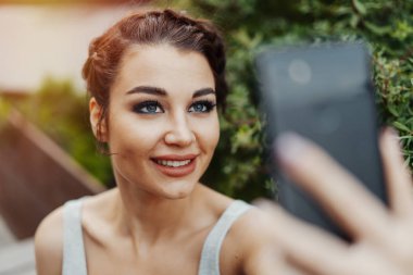 Güzel kadının selfie park ve gülümseyen yapma yakın çekim