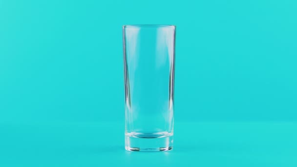 4 k close-up shot van melk koud drankje drinken massasprint in naar lage glas blauwe achtergrond in de studio — Stockvideo