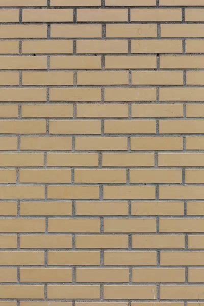 Gelb mit grauen Nähten Stein Ziegel Wandmuster Textur Hintergrund vertikale Aufnahme — Stockfoto