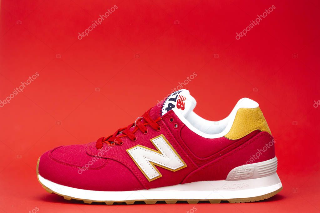 New Balance NB 574 athletic shoes on studio background. New Balance Athletics one of the worlds major sports footwear manufacturers