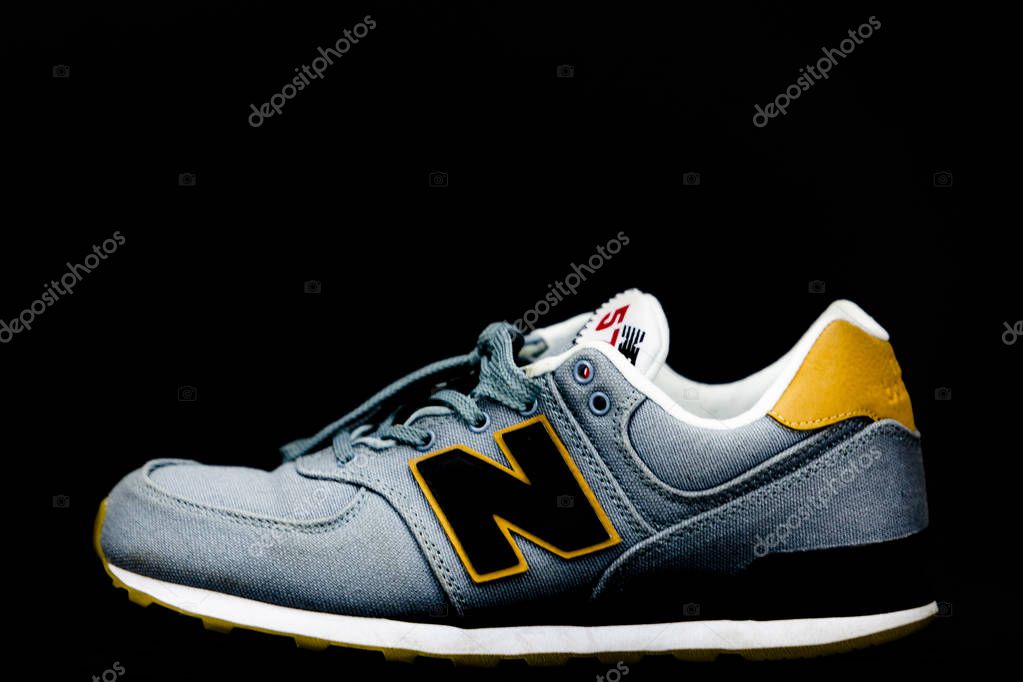 New Balance NB 574 athletic shoes on studio background. New Balance Athletics one of the worlds major sports footwear manufacturers