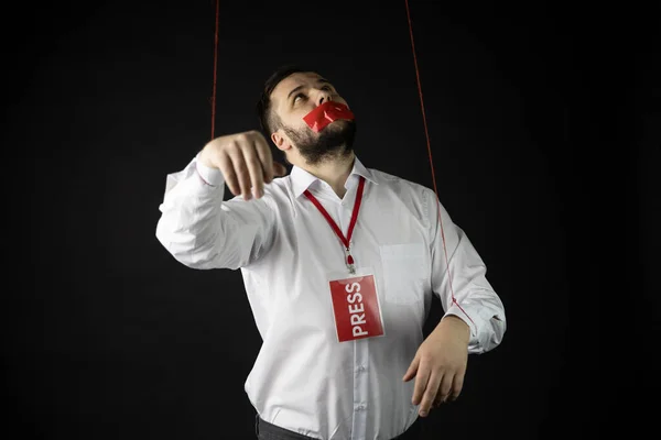 Dependent man with badge press with wrapping mouth by tape looking up