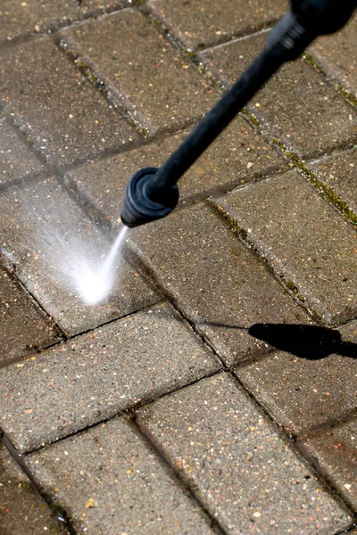 high-pressure washer clean the dirt of garden line in country house