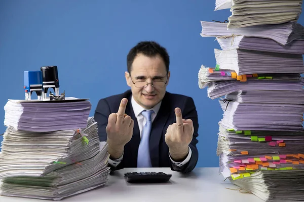 White collar strike concept. tired office worker Make a fuck sign amidst papers — Stockfoto
