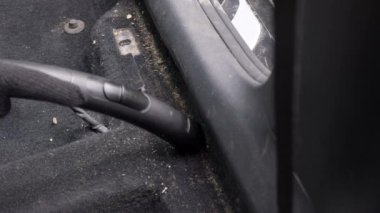 İşçi, yolcu bölümündeki koltukların altındaki çöpleri temizliyor..