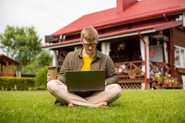 Smart freelancer works outdoors, young businessman have coffee break with laptop