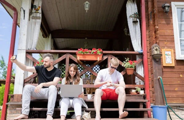 Jóvenes creativos sentados al aire libre en la terraza, mañana con aparatos digitales — Foto de Stock
