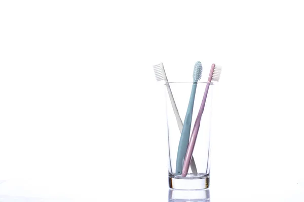 Toothbrushes in transparent glass isolated on white background, dental equipment — Stock Photo, Image