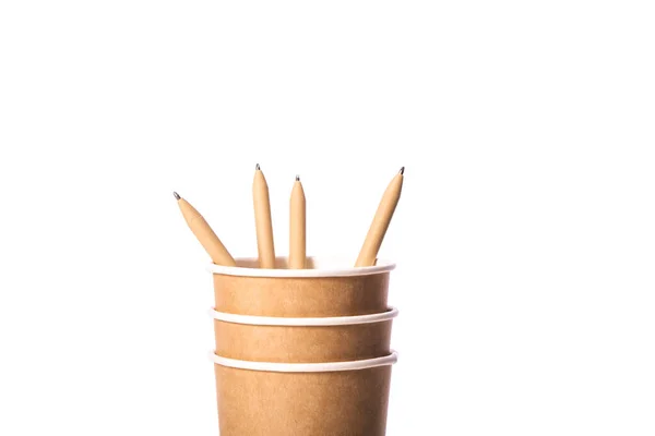 Stack of disposable paper takeaway cups with pen made of recycled paper — Stock Photo, Image