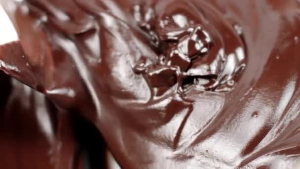 Spatula mixes thick mass melted chocolate for delicious cakes close up slow mo — Stock Video