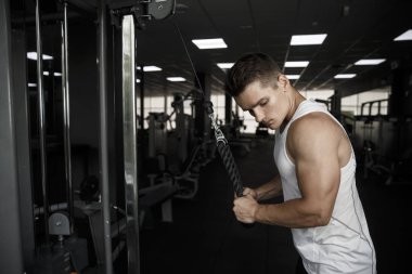 Spor yaparken yakışıklı delikanlı. Spor salonunda trenler