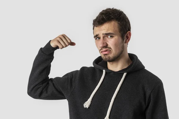 Zayıf Beyaz delikanlı disappointedly kameraya bakıyor. Beyaz arka plan üzerinde izole. Zayıflık kavramı.