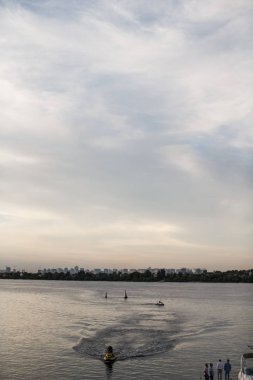 Bazı gemiler büyük nehirde yelken açmış, büyük şehir ufukta..