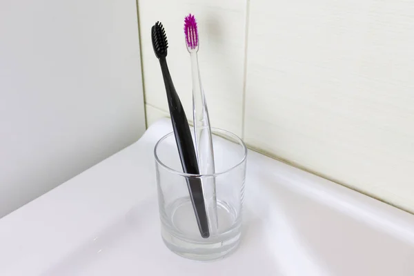 Two Toothbrushes Pink Black Color Clear Glass Bathroom — Stock Photo, Image