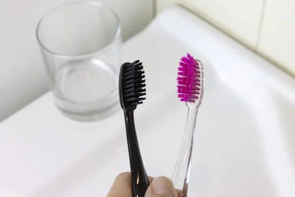 Cropped Hand Holding Two Toothbrushes Pink Black Color Background White — Stock Photo, Image