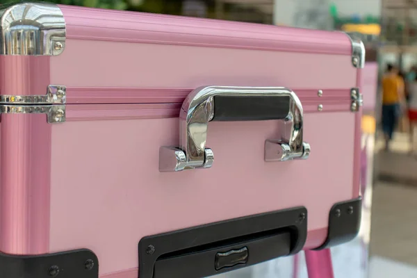 Pink shiny glamour beauty case with chrome handle. Beauty, make-up and fashion concept