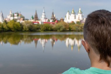 Sevimli genç çocuk seyahat ederken uzak thougthfully arıyorum. Nehir ve onun önünde güzel manzaraları.