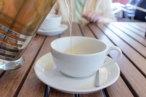 Two Teacups French Press Table Blurred Woman Pouring Tea Concept — Stock Photo, Image