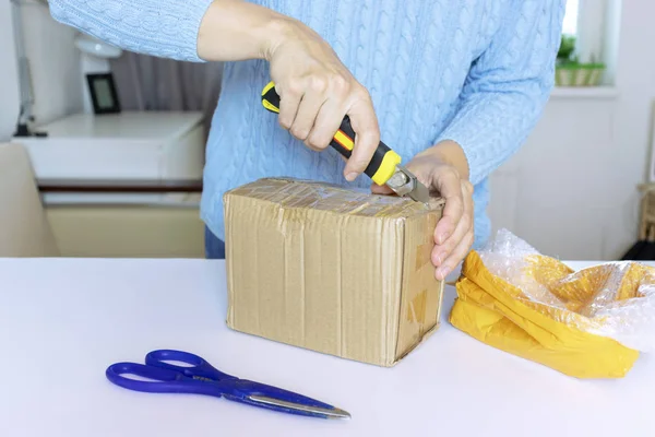 Woman Blue Pullover Unpacks Unbox Parcel Scissors Knife — Stock Photo, Image