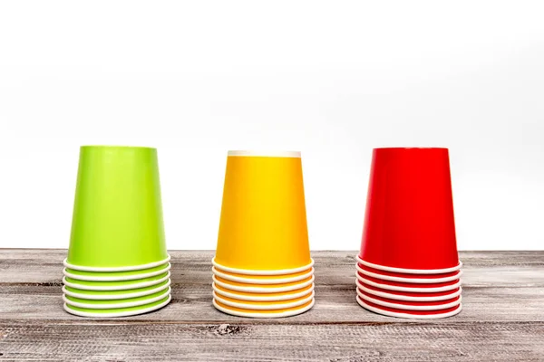 stock image Stacks of empty colorful disposable paper cups of red, yellow and green color.