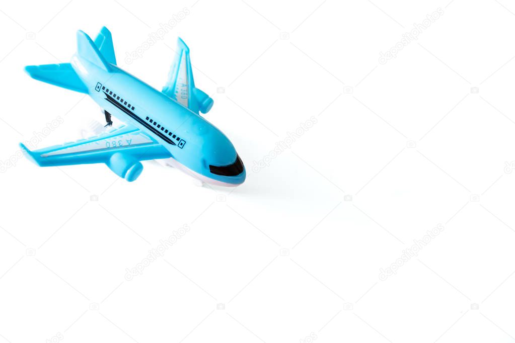 Blue toy airplane on white background with copy space, travel, journey and flying concept.