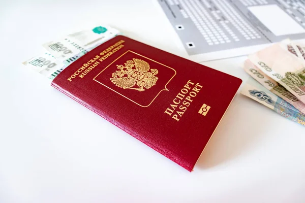 Russian passport, money and registration at the place of stay form on the table.