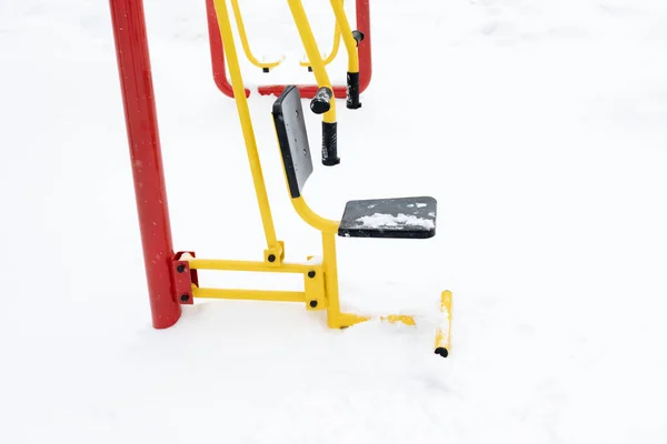 Street workout equipment in winter, outdoor sport fitness and bodybuilding.