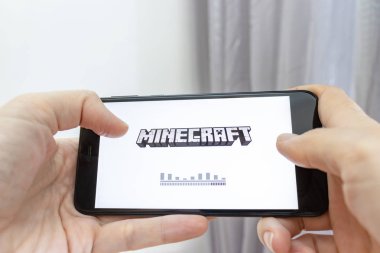 Moskova, Rusya - 08 Ocak 2018: bir smartphone online multyplayer oyun Mojang tarafından Minecraft ile holding eller.