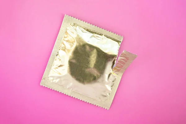 Condom Torn Foil Pack Close Pink Background — ストック写真