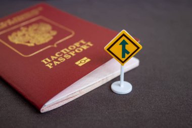 Russian international passport with a yellow arrow road sign - migration concept. clipart