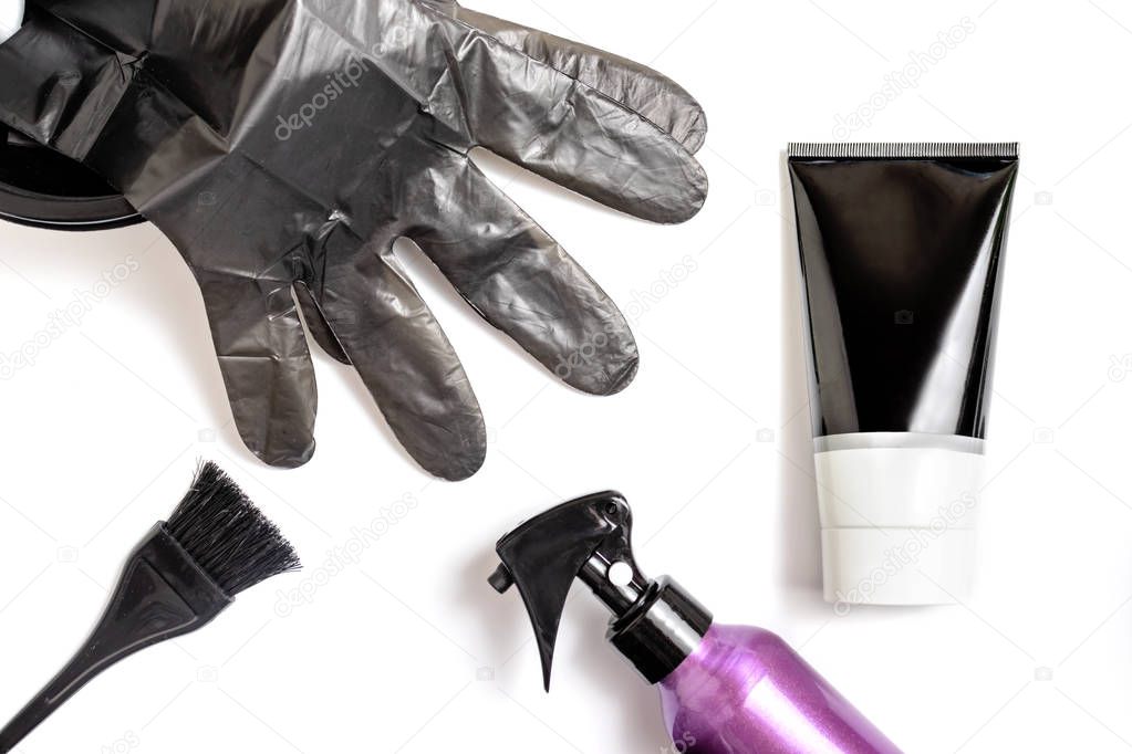 Set of professional hairdresser tools for coloring hair - bleach brush, bowl, spray, gloves and tube of coloring stuff, composition on white background